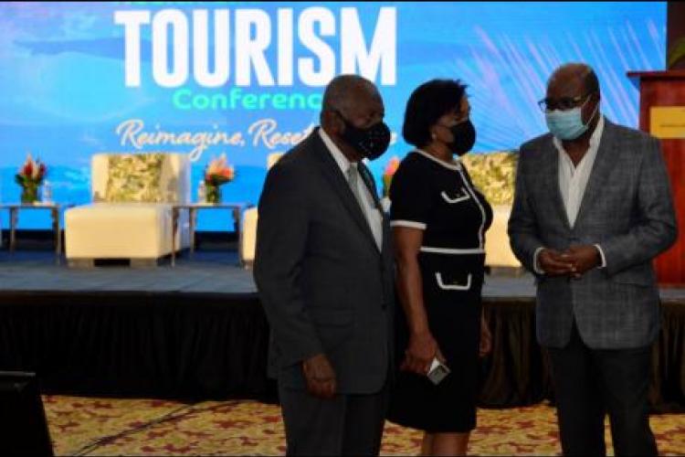 Minister of Tourism Edmund Bartlett (right), speaks with chairman of the Tourism Enhancement Fund, Godfrey Dyer and executive director of Jamaica Vacations, Joy Roberts, at the opening of the Jamaica Health and Wellness Conference on November 18, at the Montego Bay Convention Centre, St James.